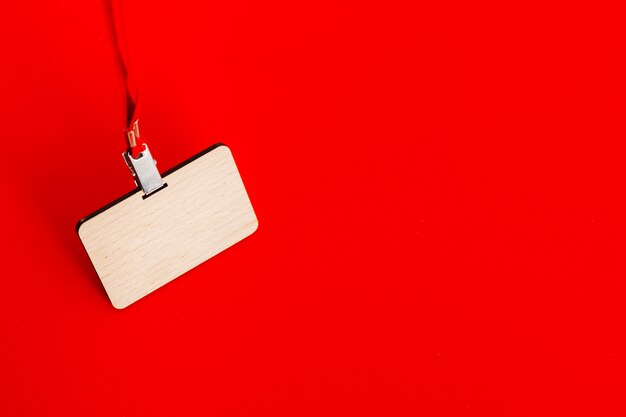 Wooden badge with lace on red background