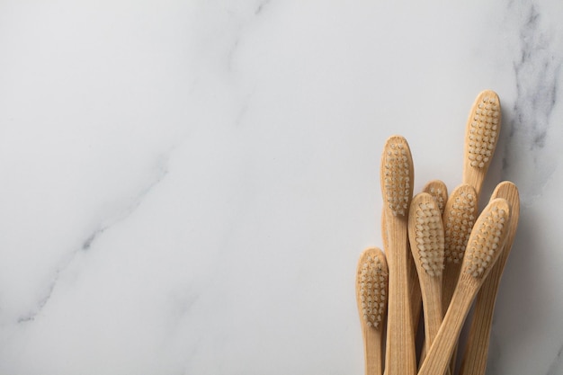 Wooden bamboo toothbrushs on a marble background