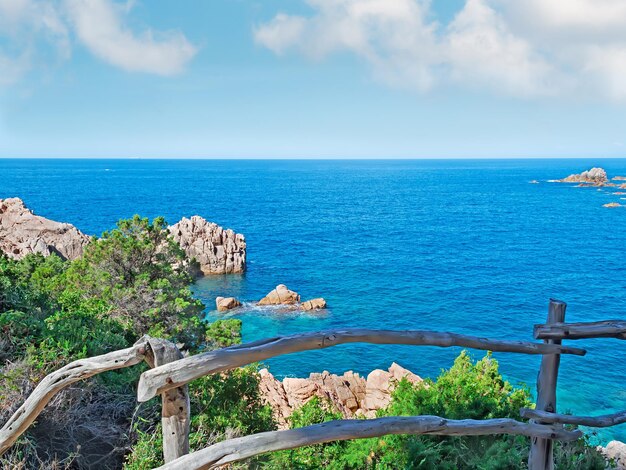 Wooden banister by Costa Paradiso coastline