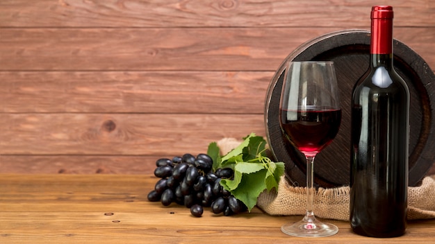 Wooden barrel with bottle and glass of wine