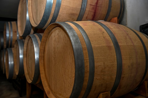 Wooden barrels for the rest of the wine inside an underground cellar