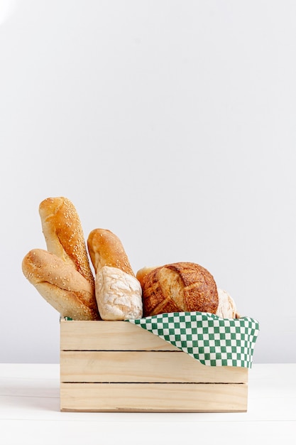 Wooden basket with bread copy space