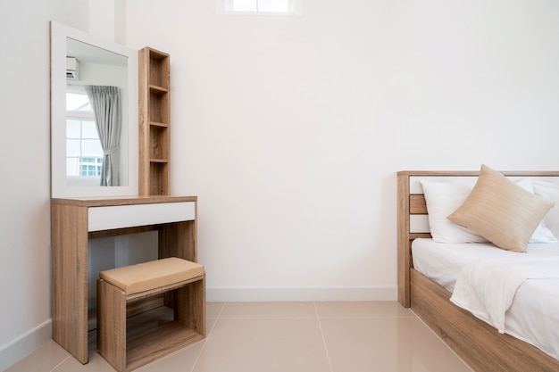 Photo wooden bed and dressing table in bedroom of house, villa, apartment and condo with a window