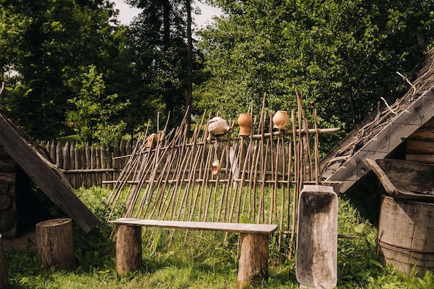 Wooden bench in the courtyard in the village on a summer day