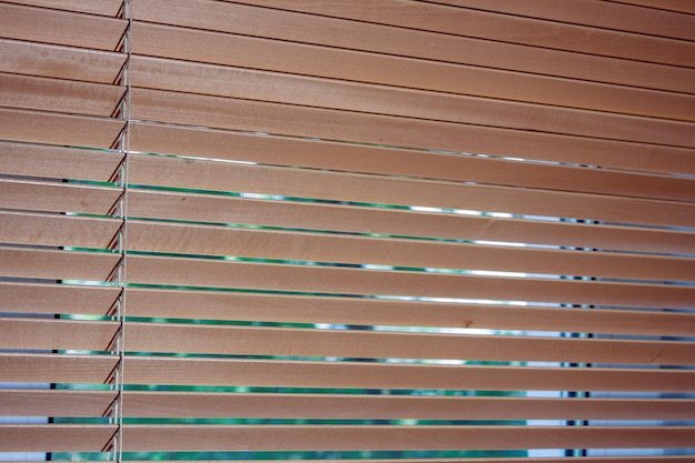 Wooden blinds hang on the window