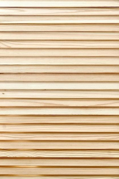 Wooden blinds made of thin plain planks and boards in contemporary carpentry workshop as background