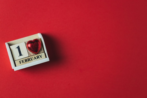 Photo wooden block calendar and red background, valentine's day theme