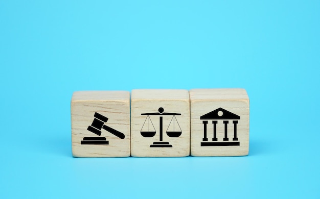 Wooden block cube shape with icon law legal justice on a blue background