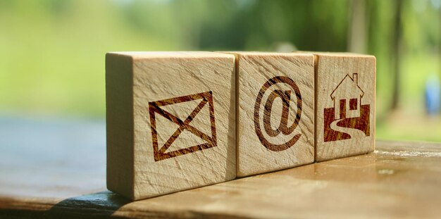 Wooden block cube symbol telephone email address and mobile phone Website page contact us or email marketing concept