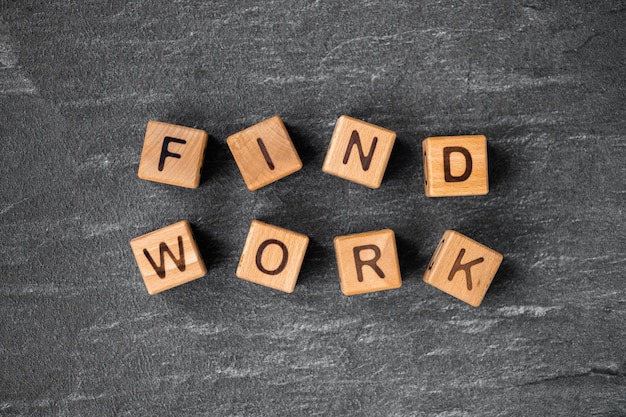 wooden block cubes with Find work words on grey background