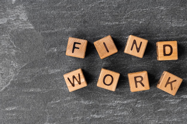 wooden block cubes with Find work words on grey background