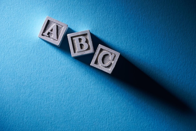 Photo wooden block with letter abc on blue background