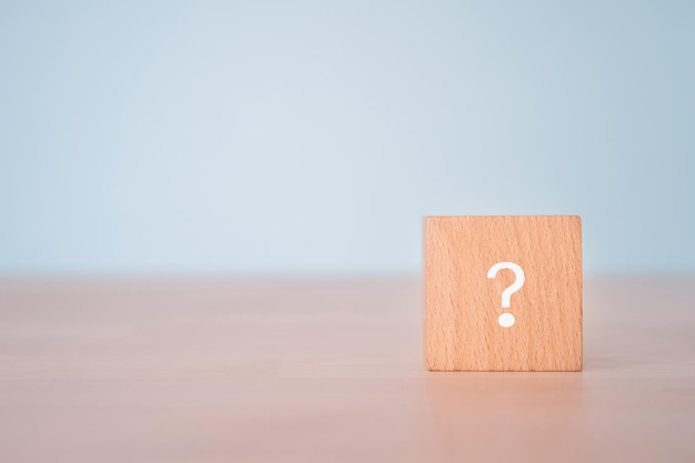 A wooden block with a question sign.