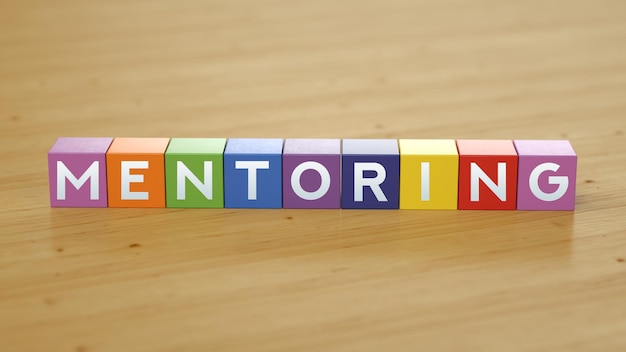 A wooden block with the word mentoring on it