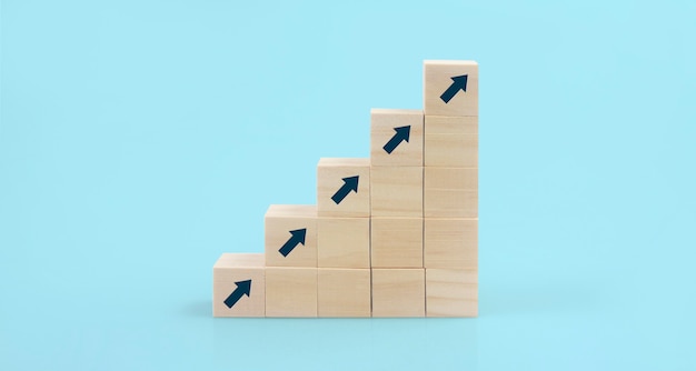 Photo wooden blocks chart steps with copy space. the business growth process