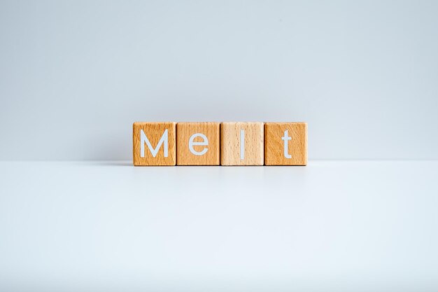 Wooden blocks form the text melt against a white background