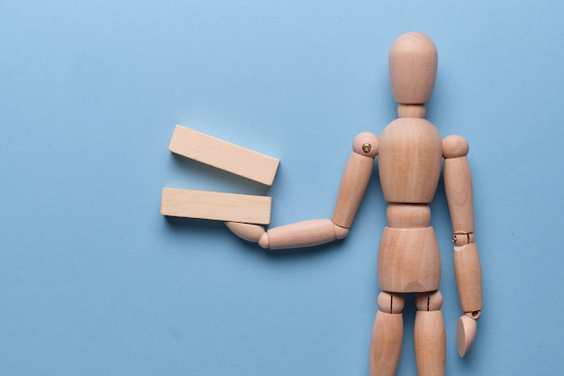 Wooden blocks holds by a mannequin