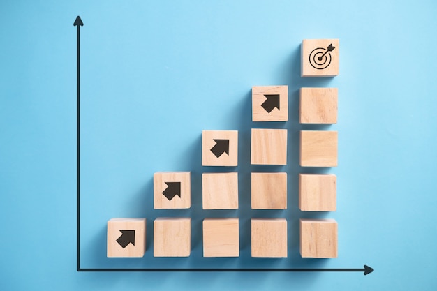 Wooden blocks staircase with arrow icon, Business planning concept.