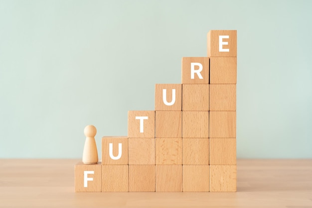 Wooden blocks with FUTURE text of concept and a human toy.