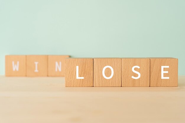 Wooden blocks with lose win text of concept.