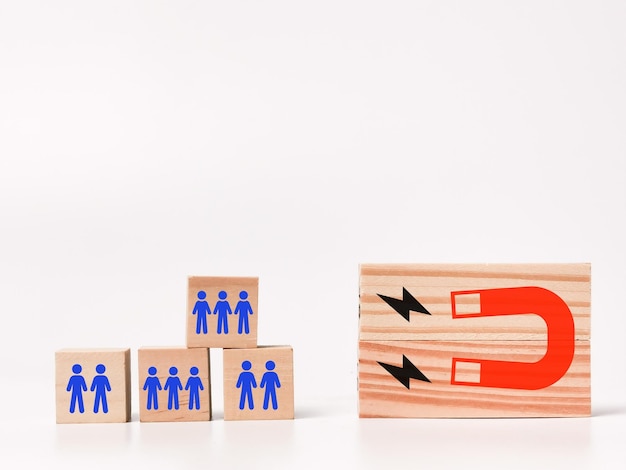 Wooden blocks with magnet and peoples icons. customer retention\
concept.