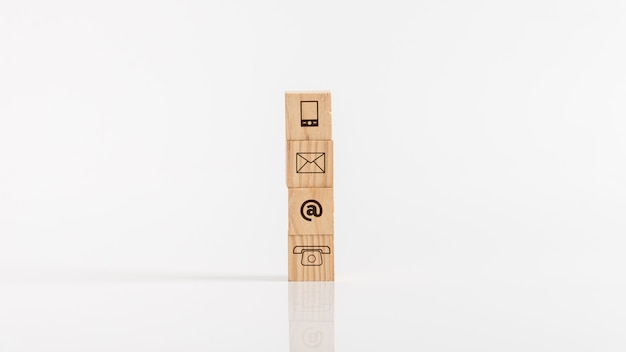 Wooden blocks with means of communications icons against white background.