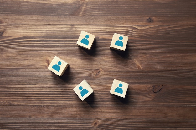 Wooden blocks with people icon on wooden