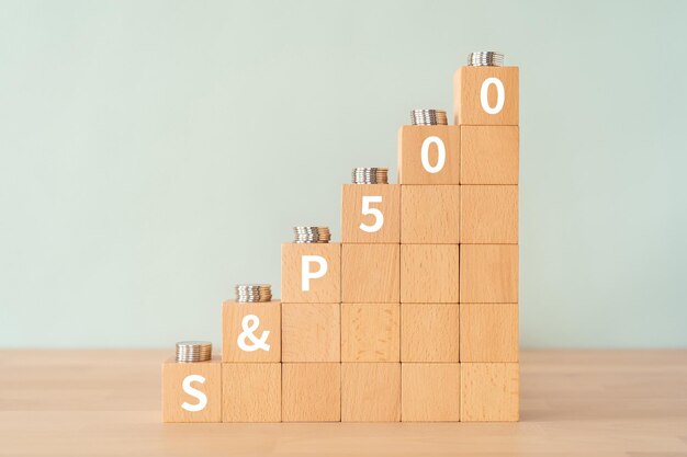 Wooden blocks with S and P 500 text of concept and coins.