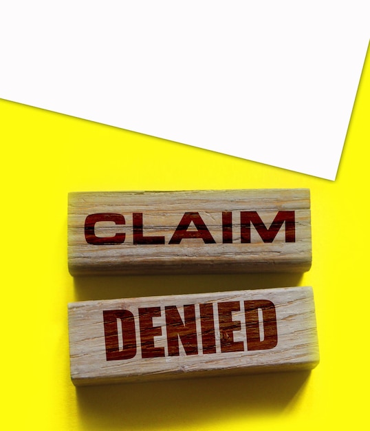 Wooden Blocks with the text Claim Denied Insurance Business concept