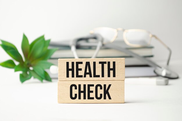 Wooden blocks with text Health Check with stethoscope Medical concept