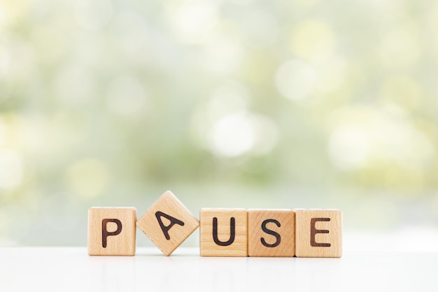 Wooden Blocks with the text Pause on a green background