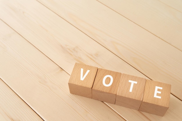 Wooden blocks with VOTE text of concept.