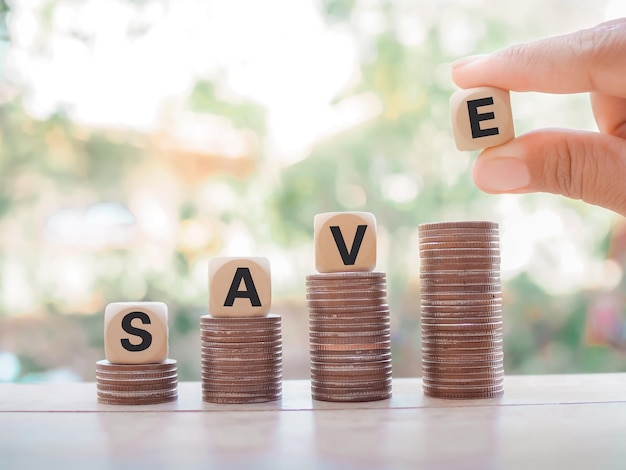 Wooden blocks with the word SAVE on coins. The concept of save money for prepare in the future