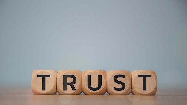 wooden blocks with the word trust building trust in business concept