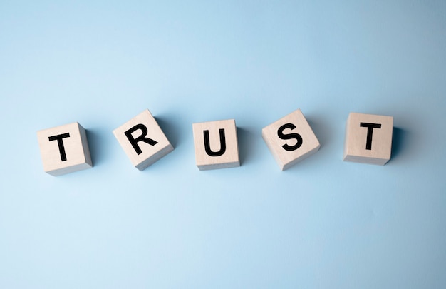 wooden blocks with the word trust. trust relationships between business partners, friends, relatives.