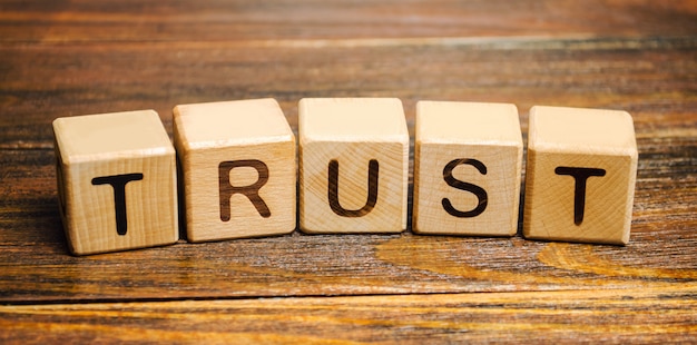 Photo wooden blocks with the word trust.