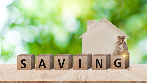wooden blocks with words saving and home us dollar money bag for investment loan planned future concept saving charity family finance plan concept fundraising superannuation financial crisis concept