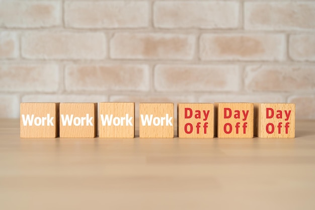 Wooden blocks with Work and Day Off text of concept.