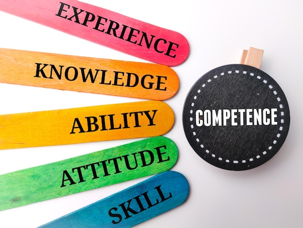 Photo wooden board and colored stick with the word competence concept