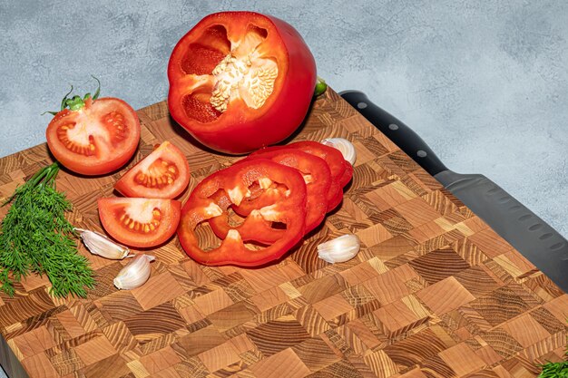 Wooden board for cutting handmade products with chopped vegetables On a light background