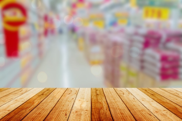 Wooden board empty table in front of blurred background. Perspective light wood over blur in supermarket - can be used for display or montage your products. Mock up for display of product.