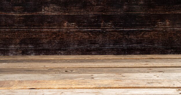 Wooden board empty table in front of dark wall background