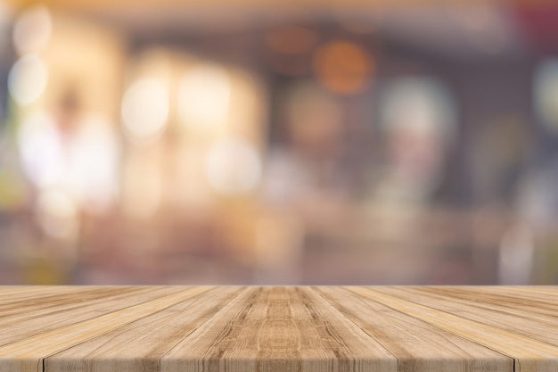 Wooden board empty table in front of in restaurant blurred background.