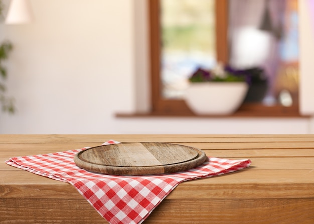 Wooden board stand on tablecloth over grunge background