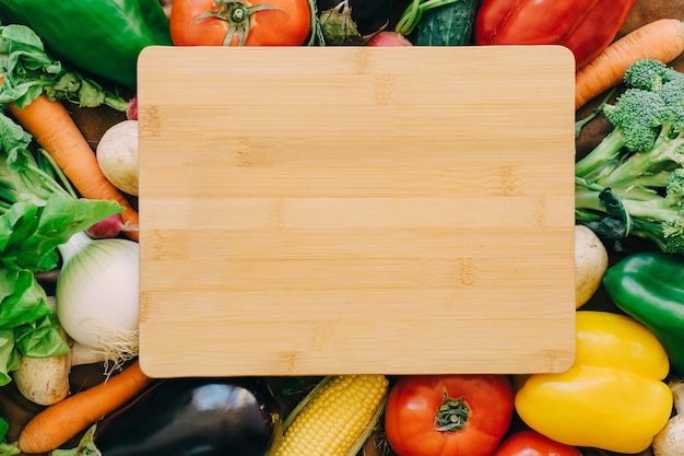 Wooden board on vegetables