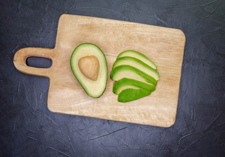 wooden board with avocado