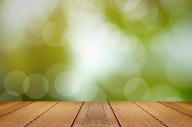 Wooden board with green blurred background.