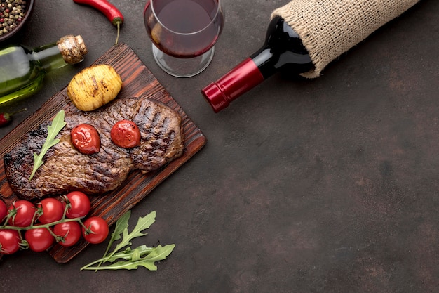 Wooden board with grilled meat with copy-space