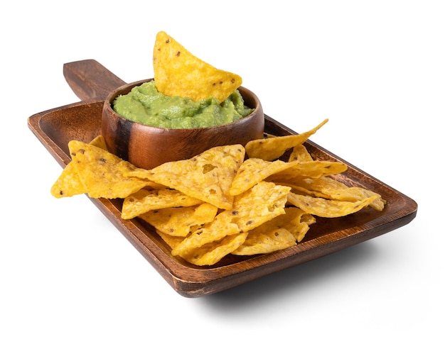 A wooden board with guacamole sauce and nachos isolated from the white background