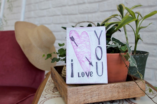 Wooden board with the signature Love Gift with a heart for Valentine's Day Present for your beloved on February 14